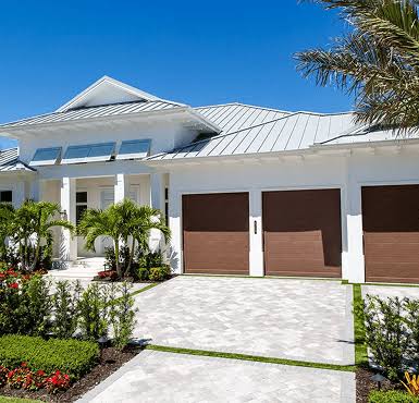 Integrated white gutters and trim visible on a residential home with a white metal roof