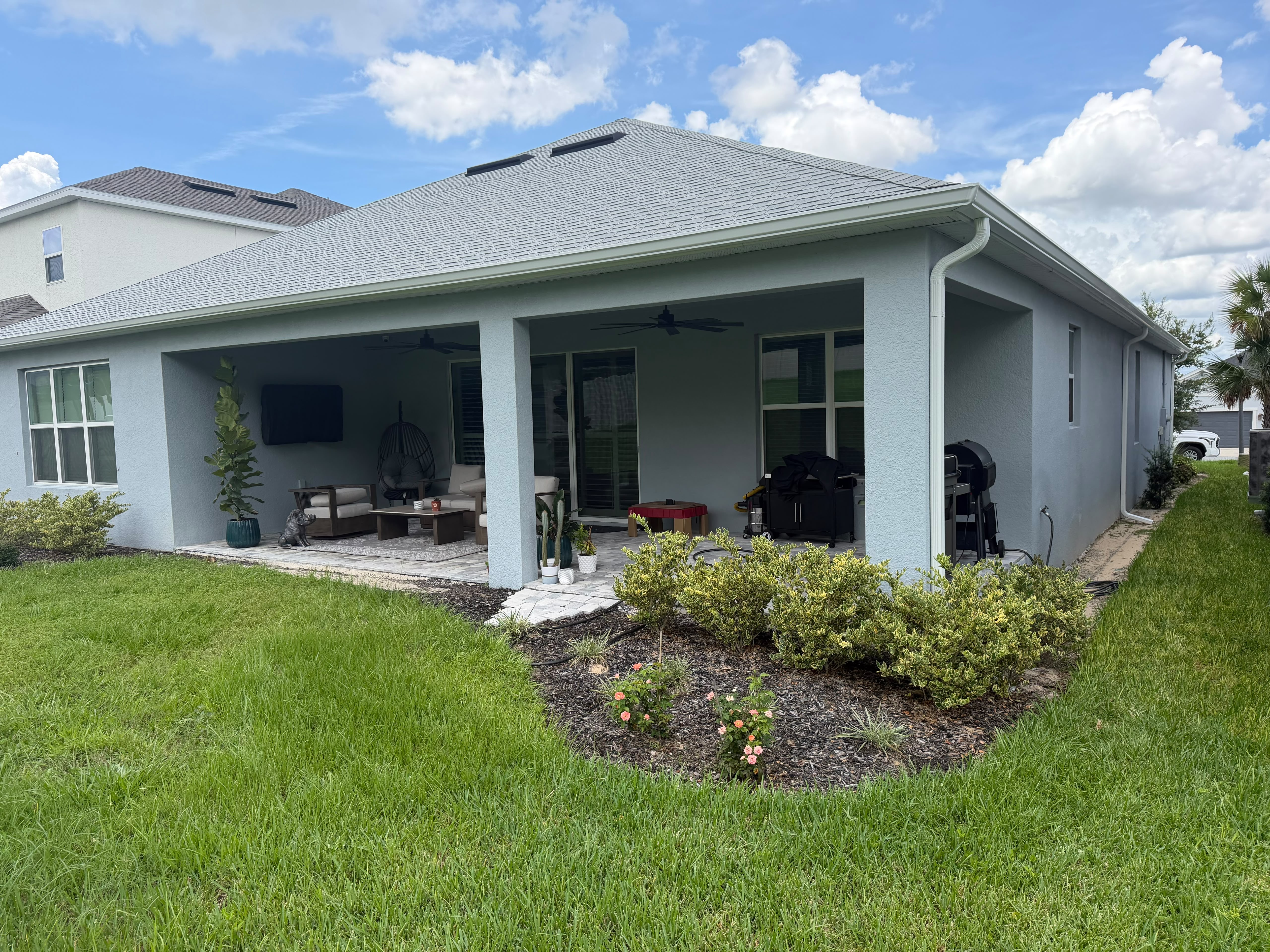 Long dark seamless gutter run along the rear roofline of a Florida home
